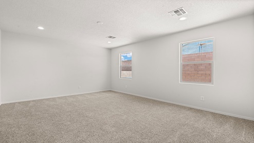 living area with windows and door leading backyard