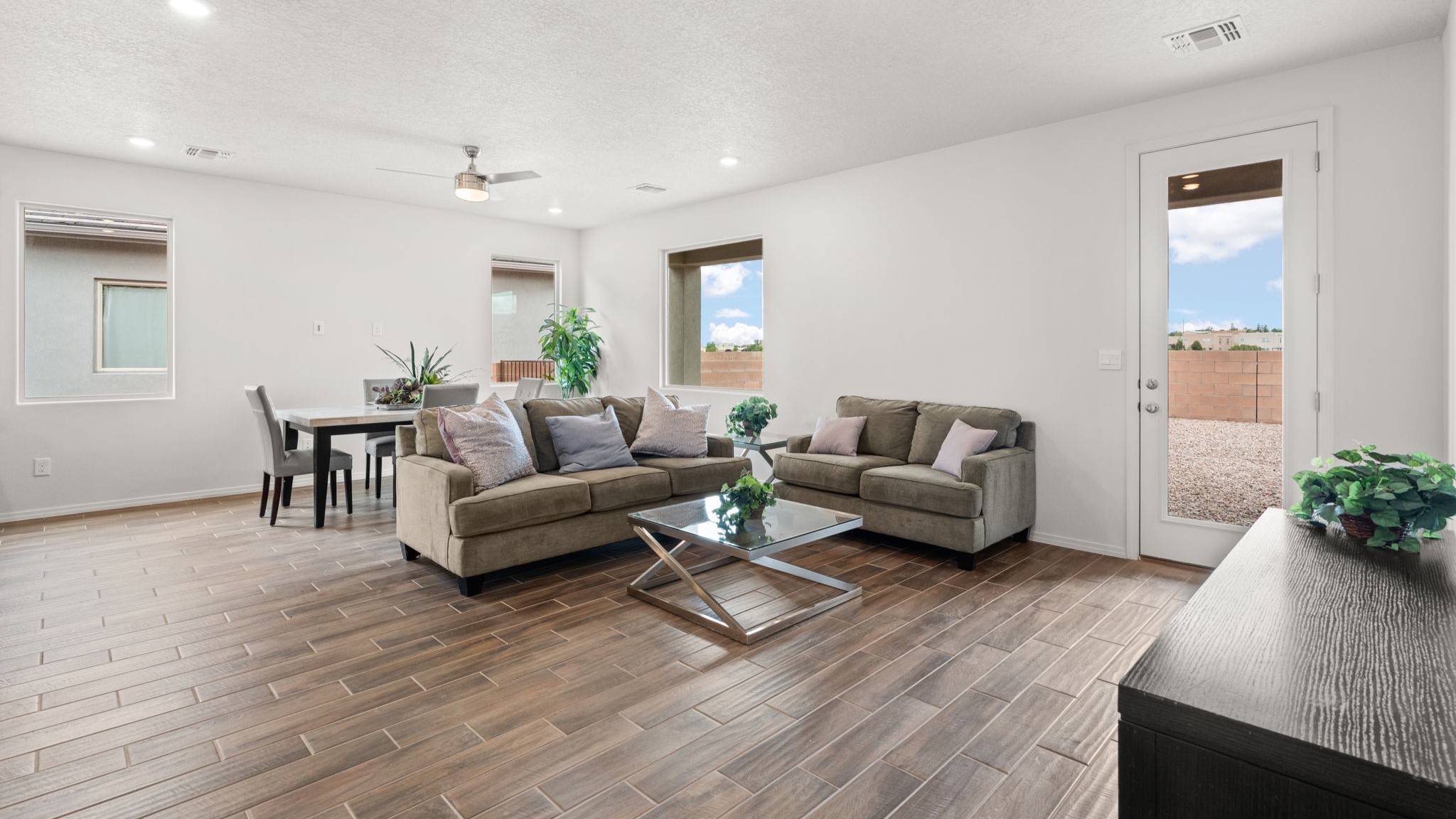 Bliss living room with ceiling fan, tile floors