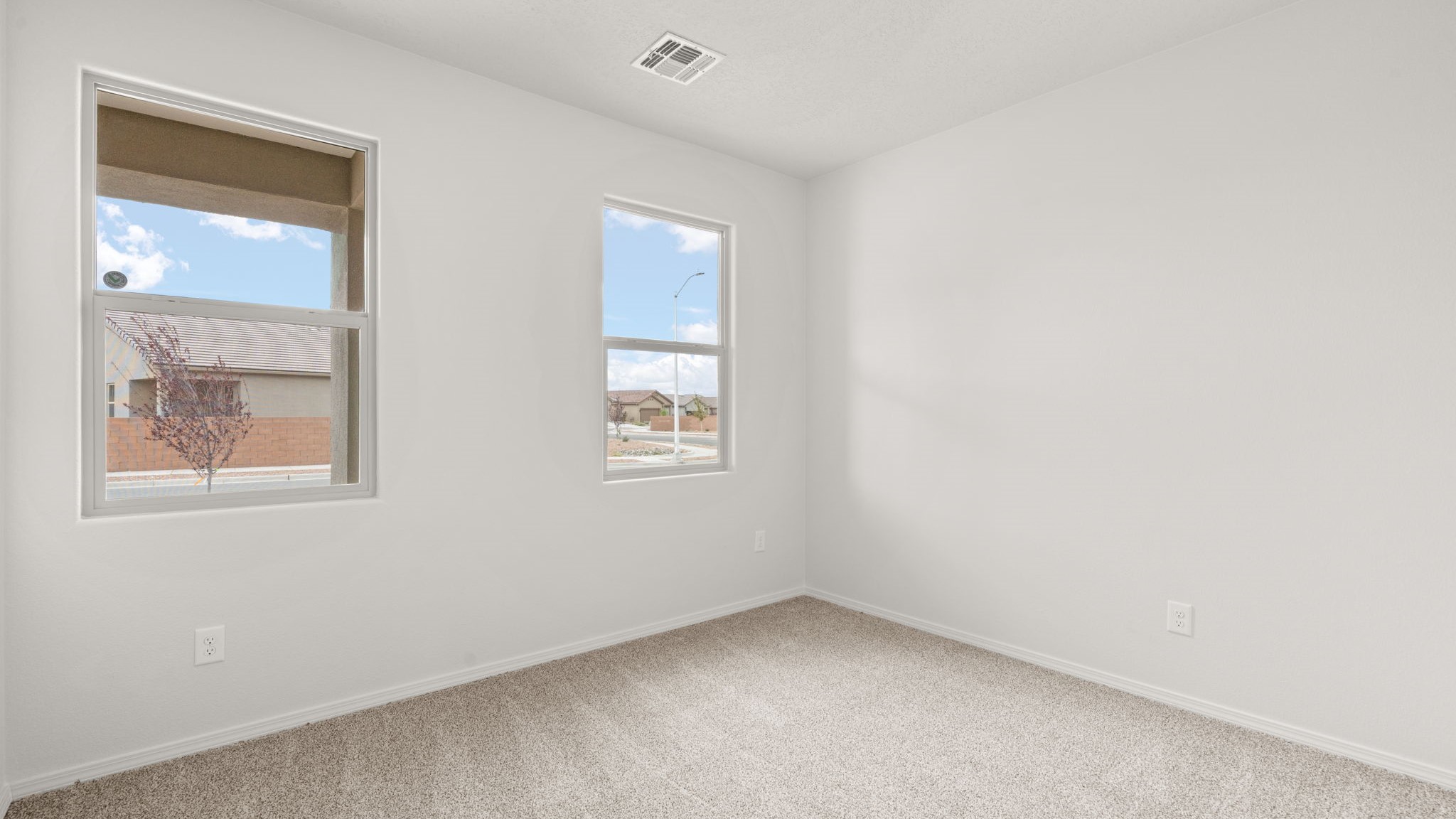 Downstairs bedroom 2 with carpet and window