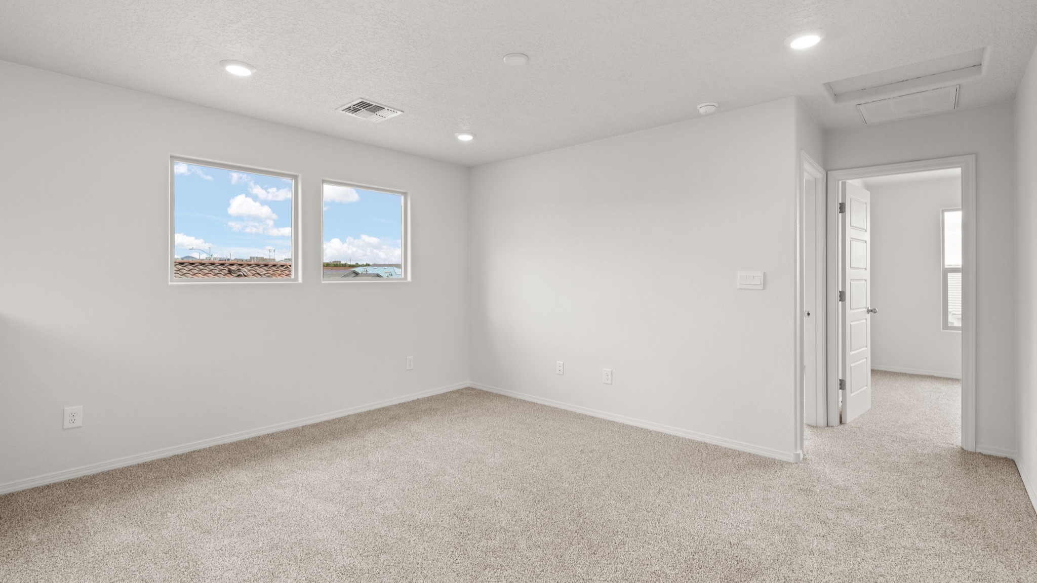 Upstairs loft with carpet and windows