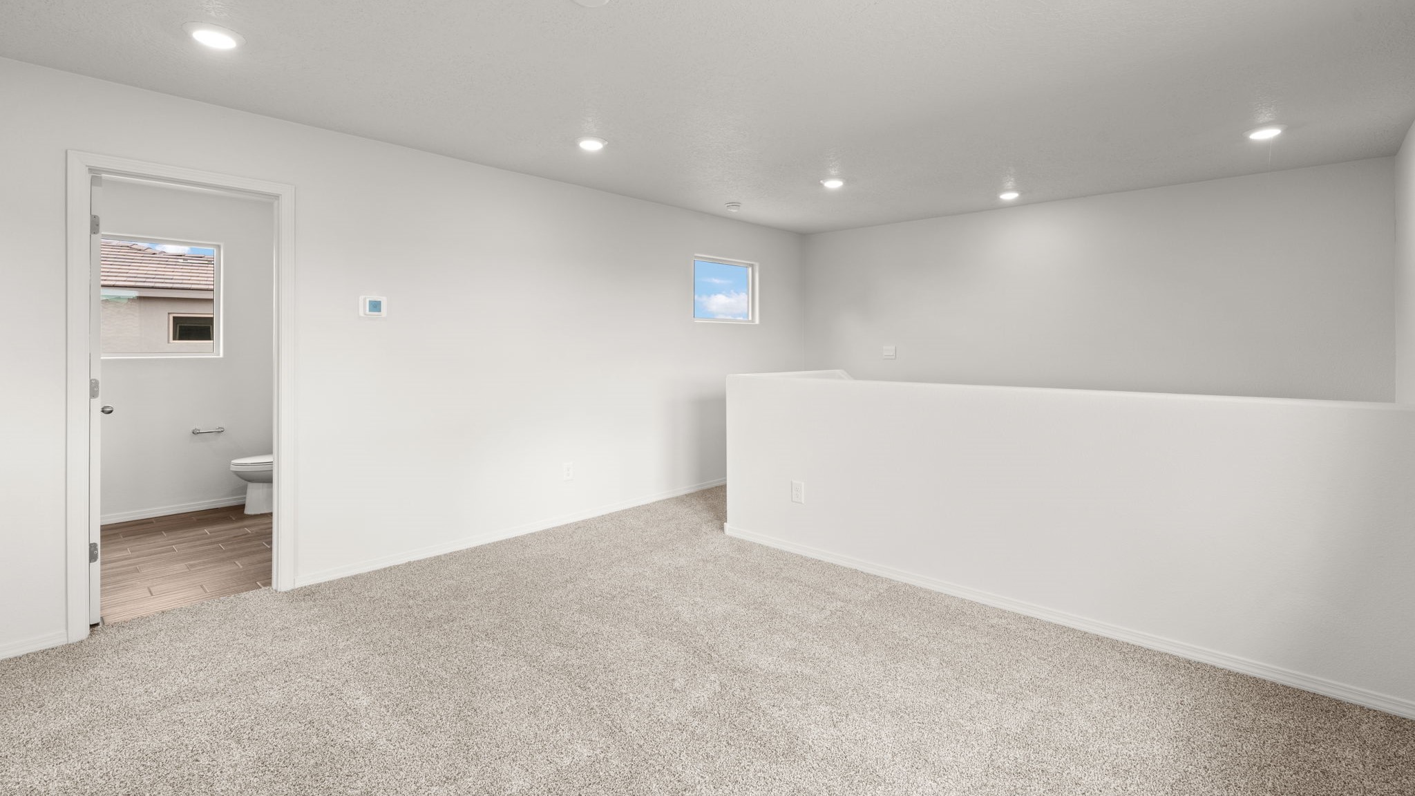 UPstairs loft with carpet and windows
