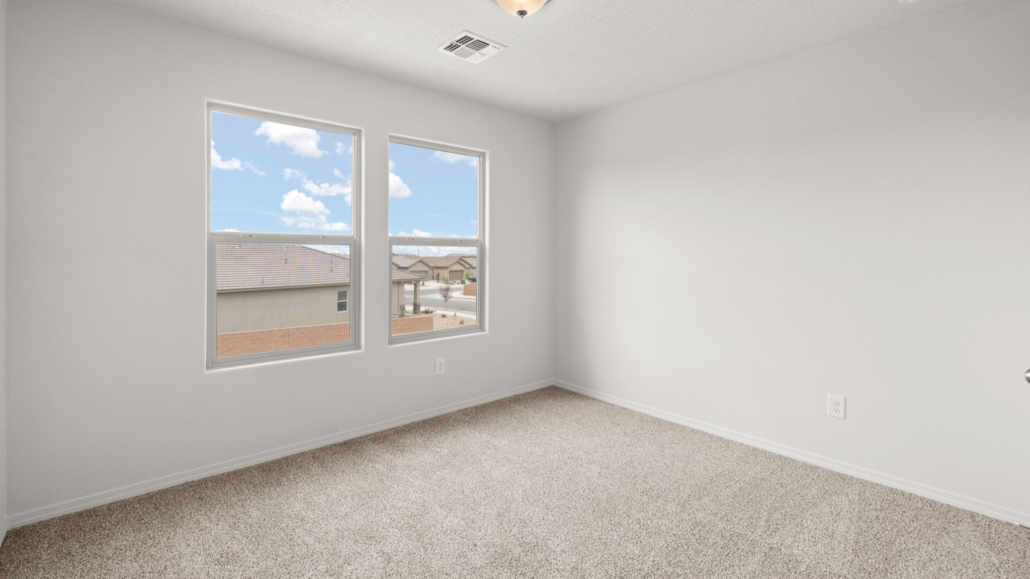 Upstairs Bedroom 4 with carpet, closet and two windows