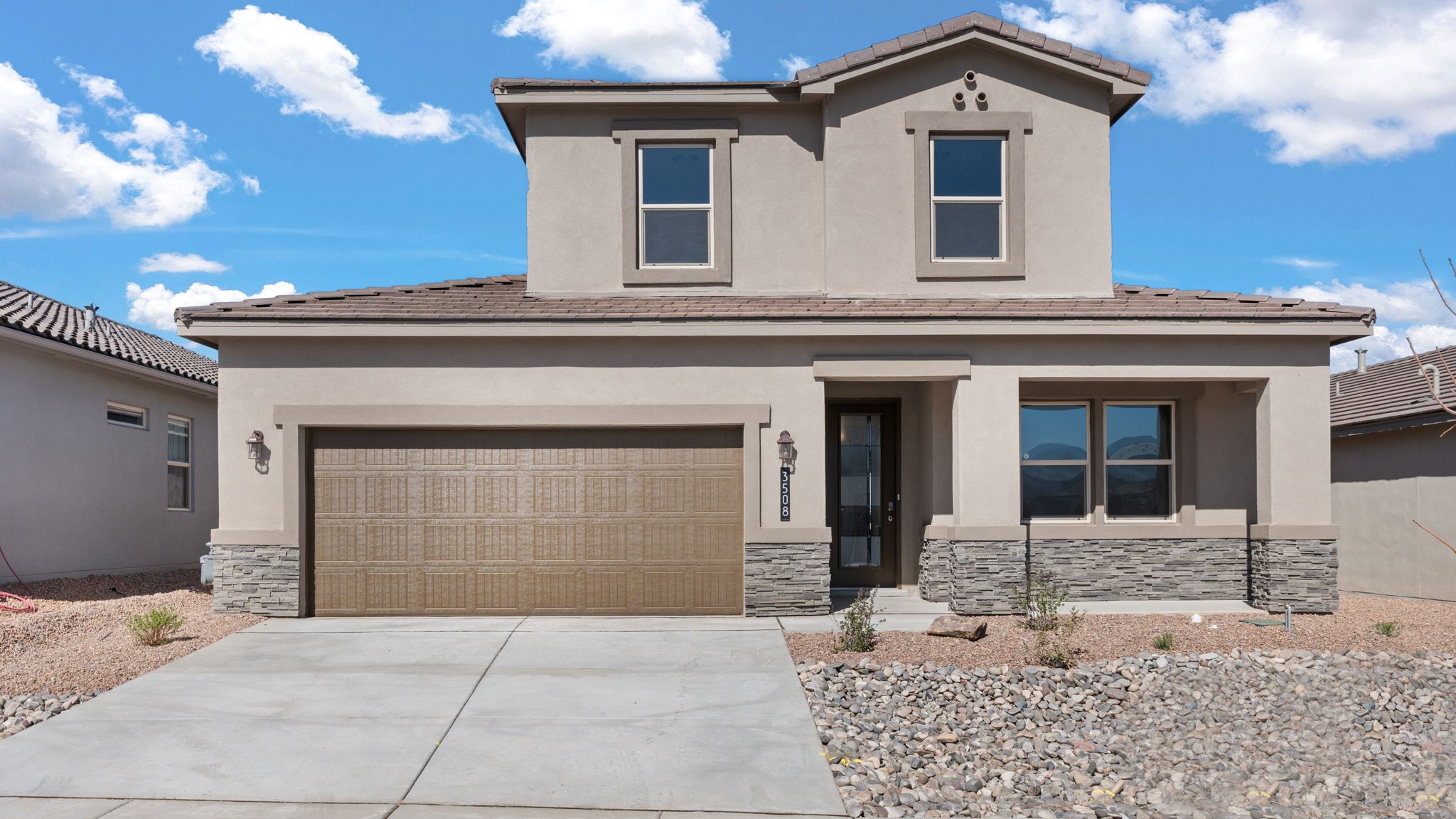 Melody exterior image with stone accents and brown stucco