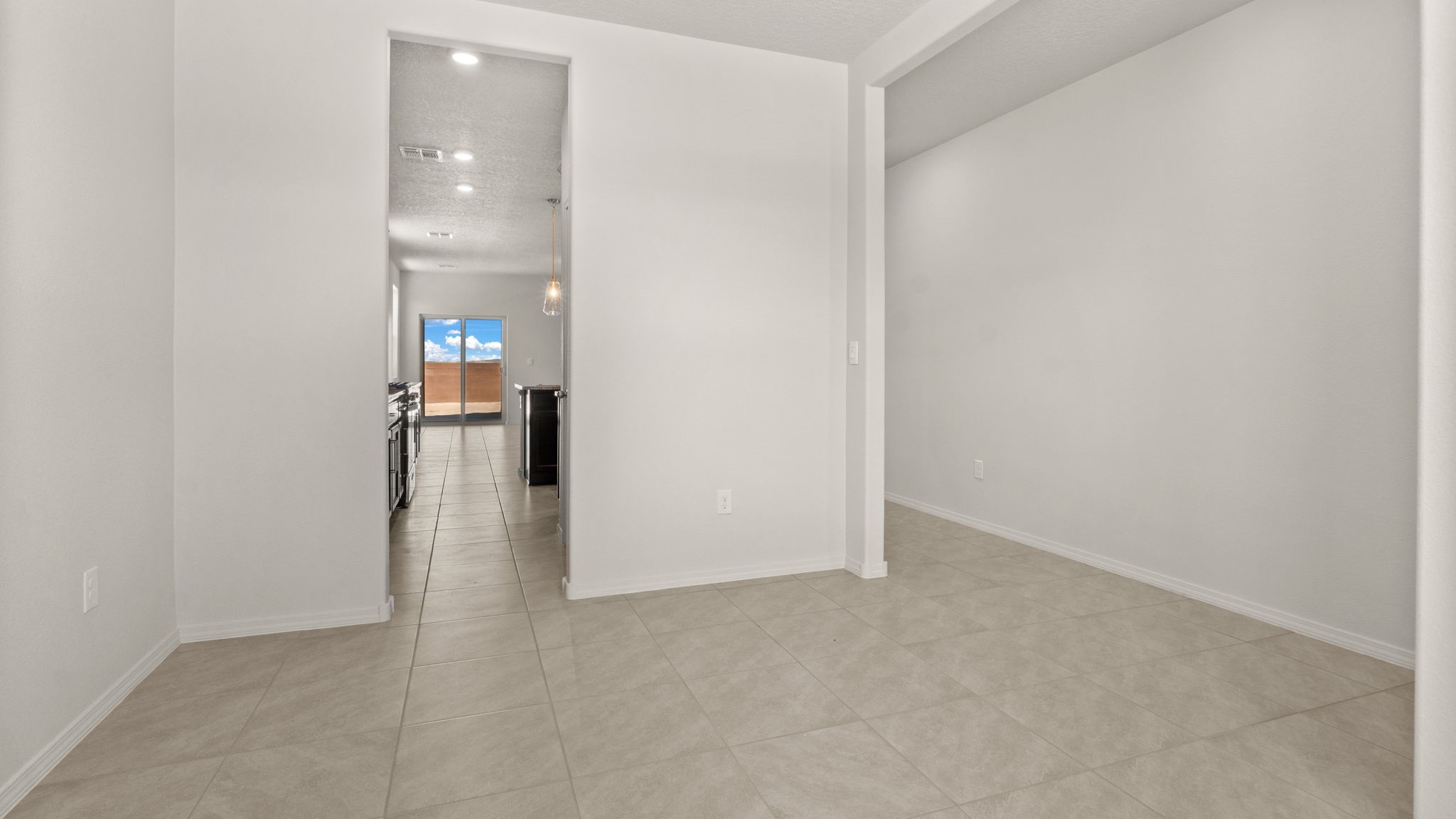 Foyer with open sightlines toward living, dining, and kitchen areas at Vista Grande