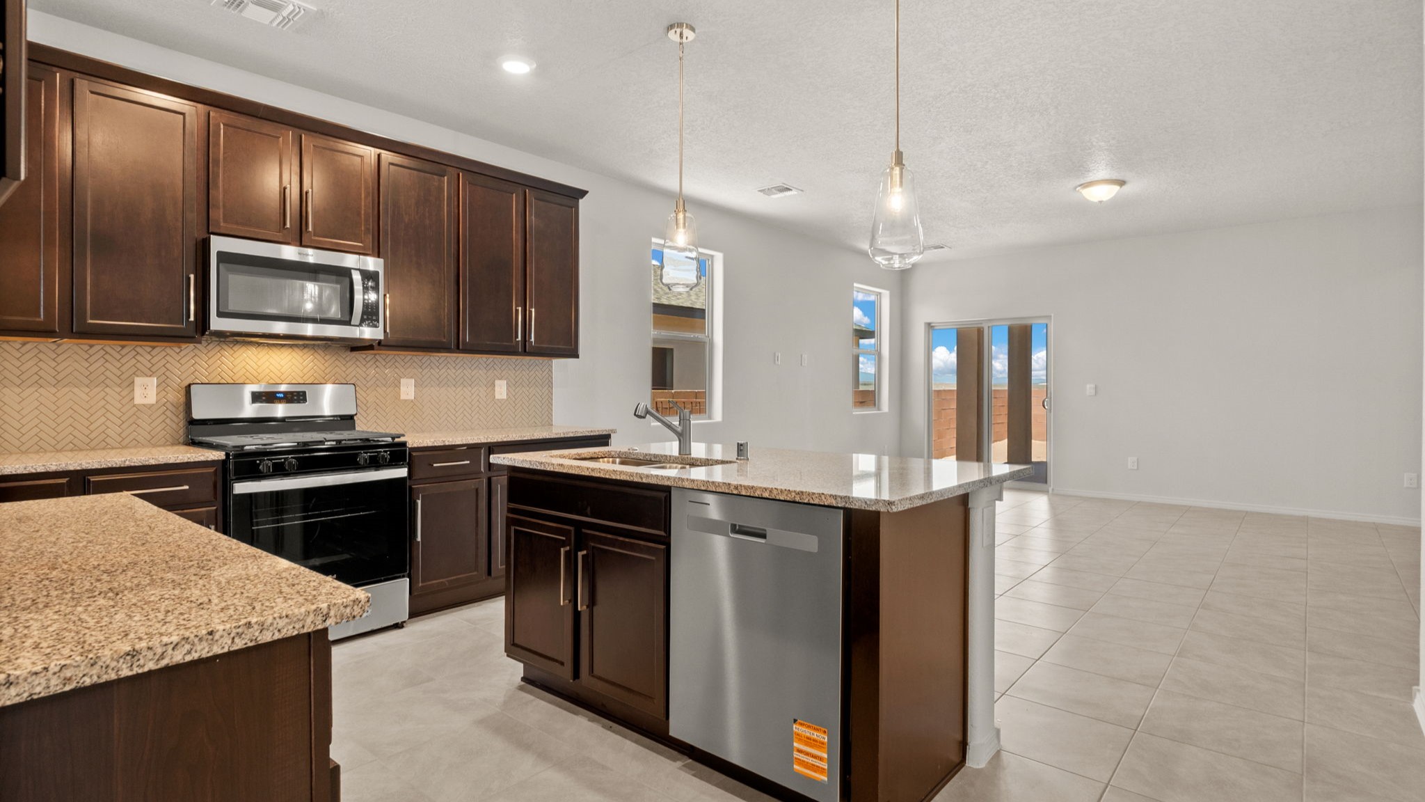 Kitchen looking toward outdoor and living areas showing open flow and enjoying natural lighting at Vista Grande
