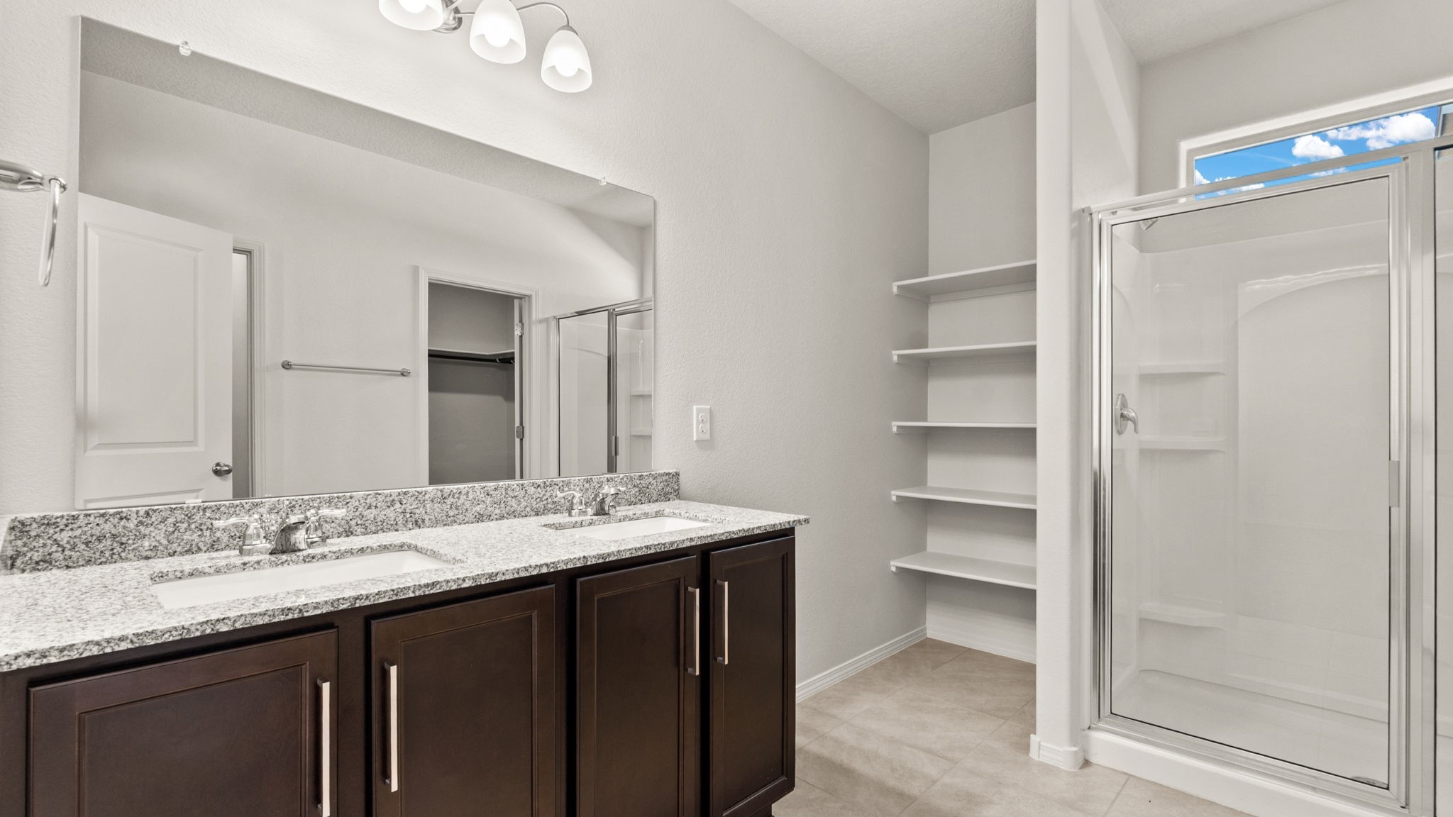 Ensuite owner’s bathroom with bright finishes, walk-in shower, and generous vanity space at Vista Grande