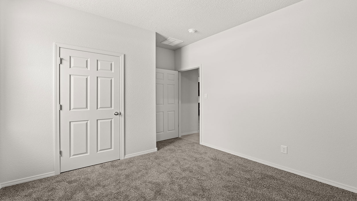 Secondary bedroom with carpet floor, one window and closet with door