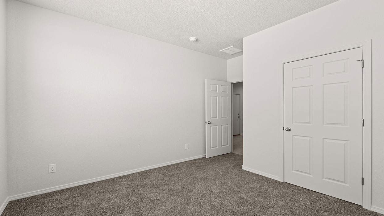 Secondary bedroom with carpet floor, one window and closet with door