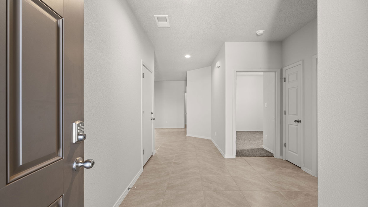Front door and entry way with tile floor and coat closet