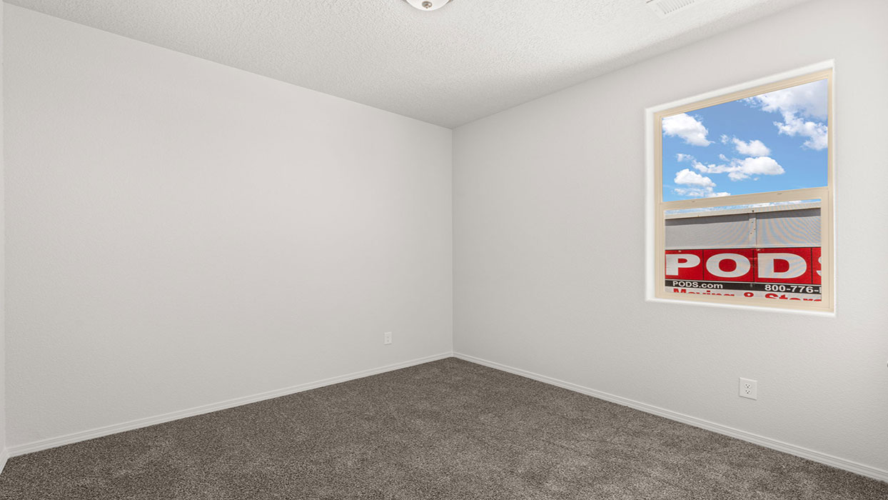 Secondary bedroom with carpet floor, one window and closet with door