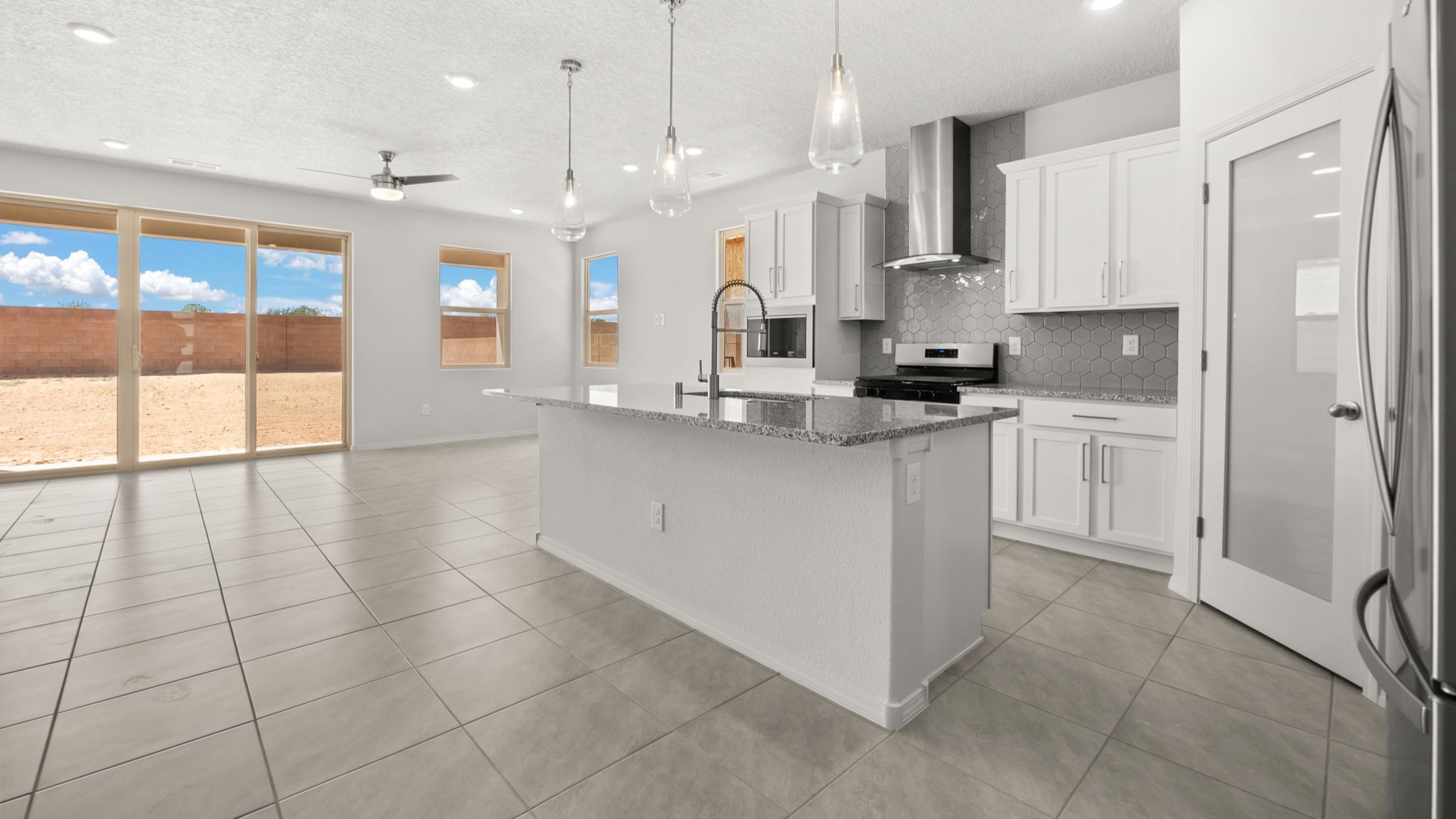 Kitchen featuring white cabinets, stainless steel appliances, and white counter tops.