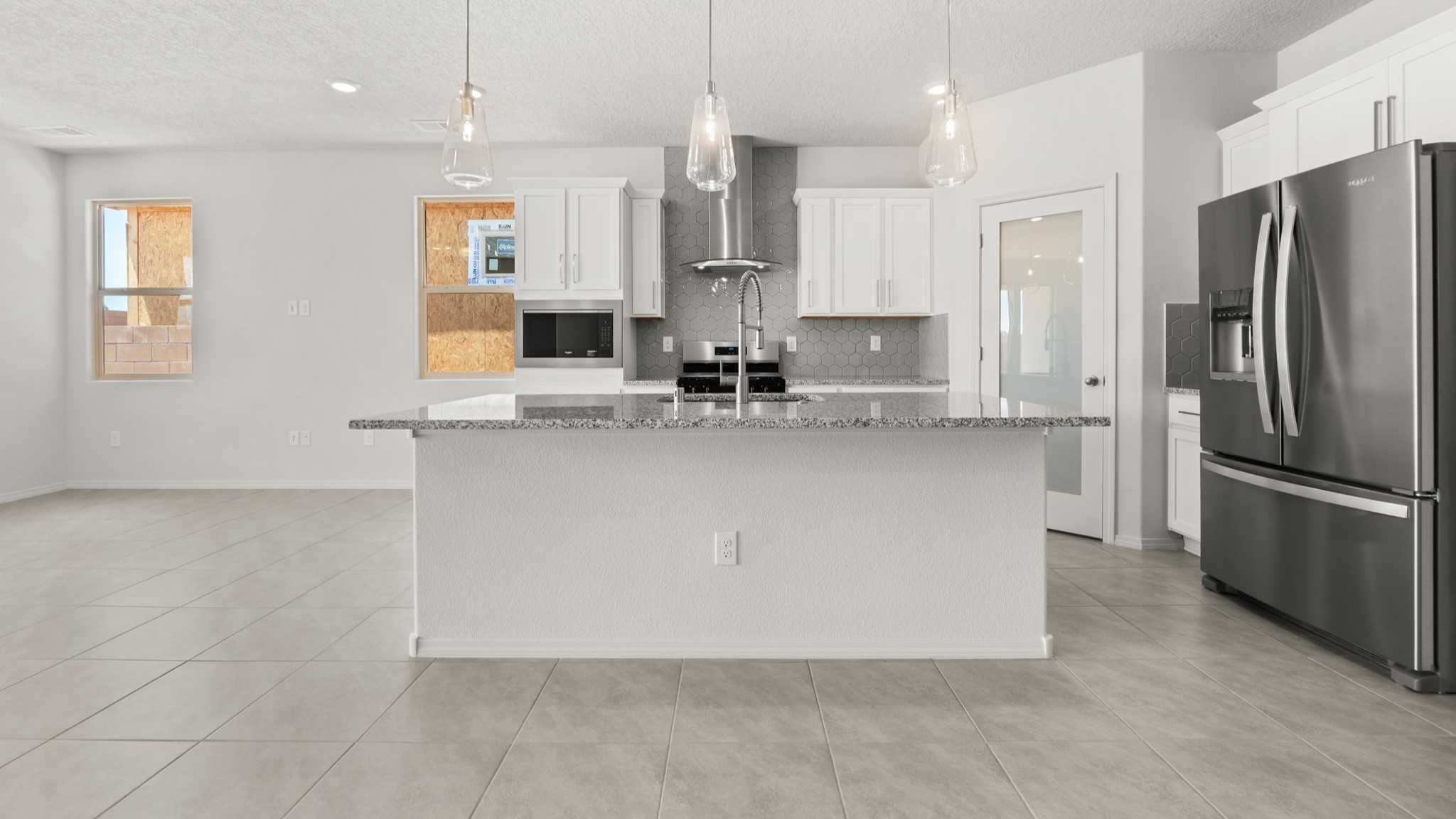 Kitchen featuring white cabinets, stainless steel appliances, and white counter tops.