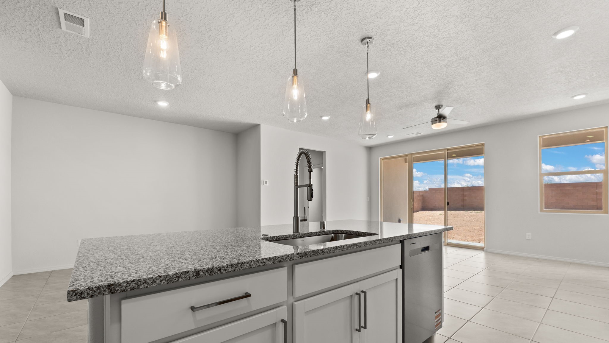 Kitchen featuring white cabinets, stainless steel appliances, and white counter tops.