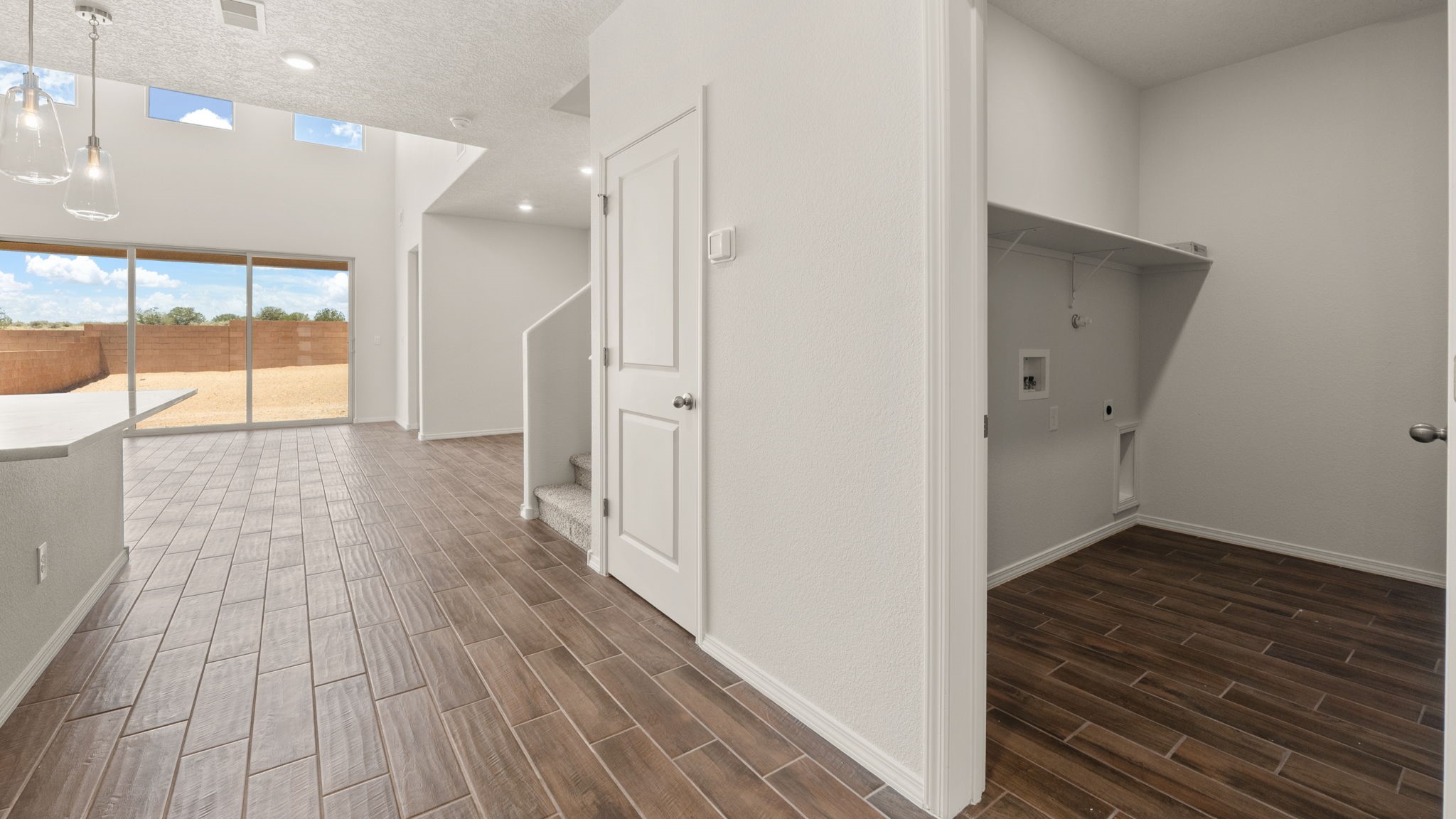 Hallway off the kitchen with a door to the laundry room.
