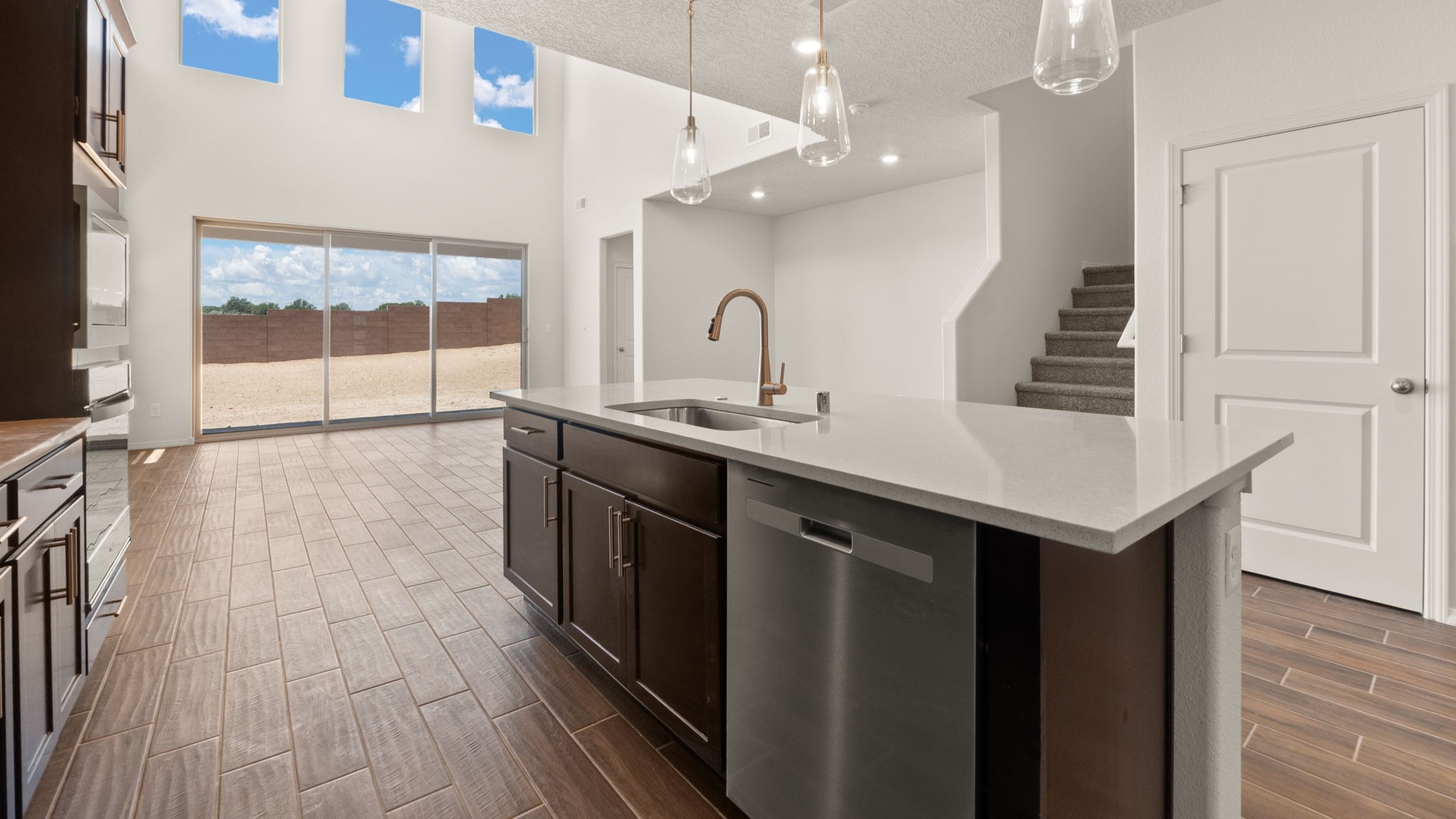 Kitchen with brown cabinets, stainless steel appliances, and white countertops.