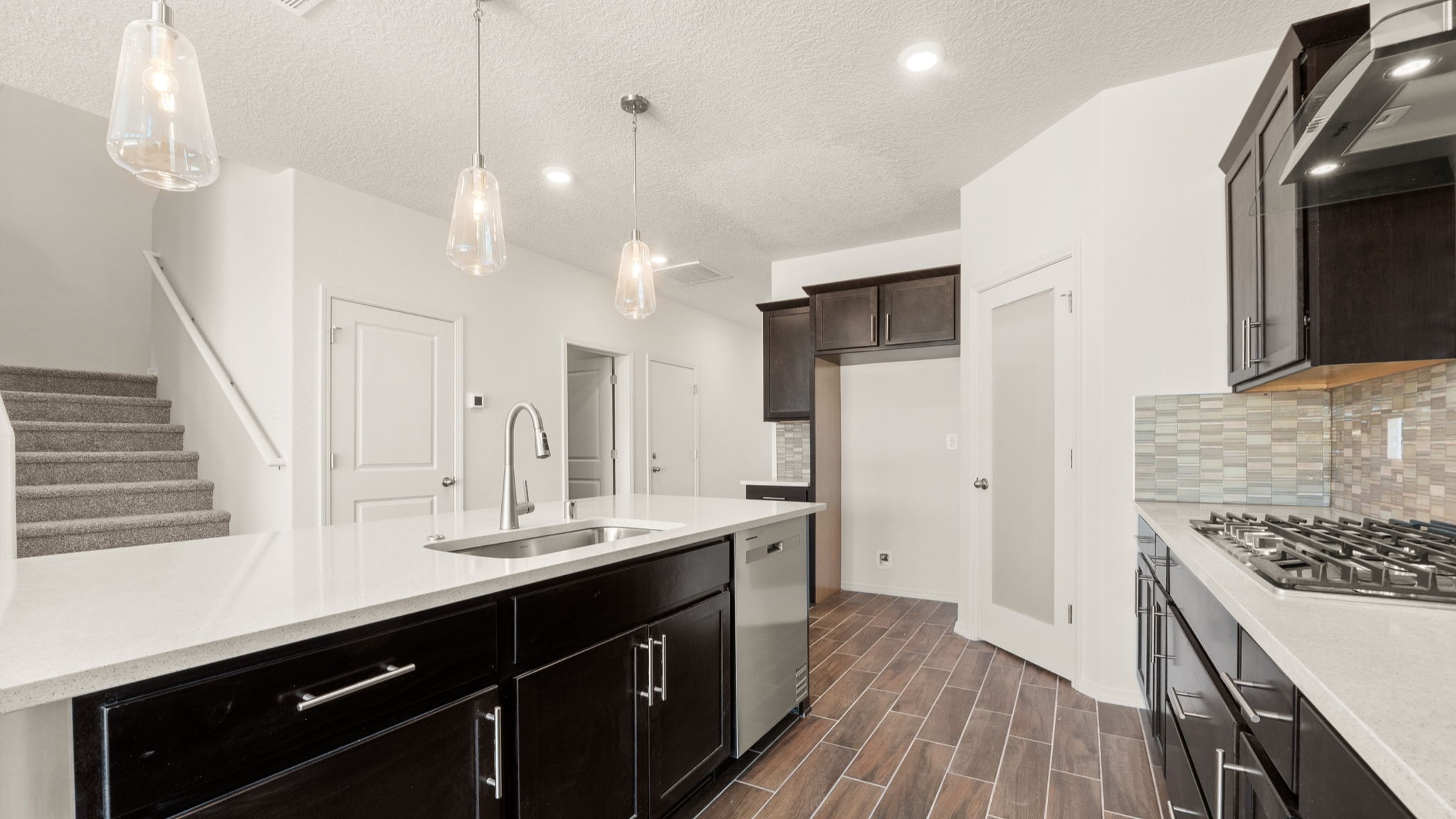 Kitchen with brown cabinets, stainless steel appliances, and white countertops.