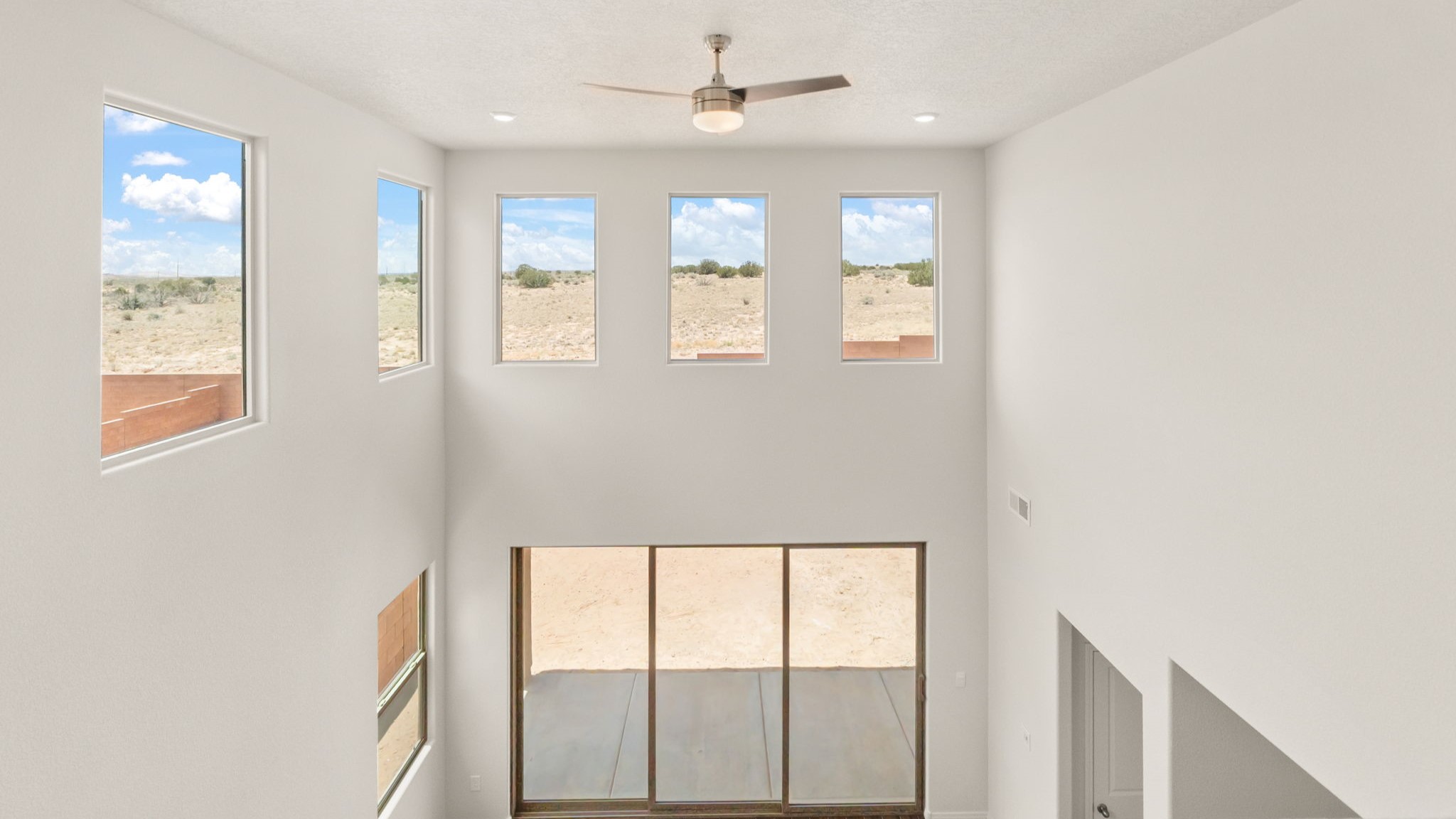 View from the top of the stairs with large windows.