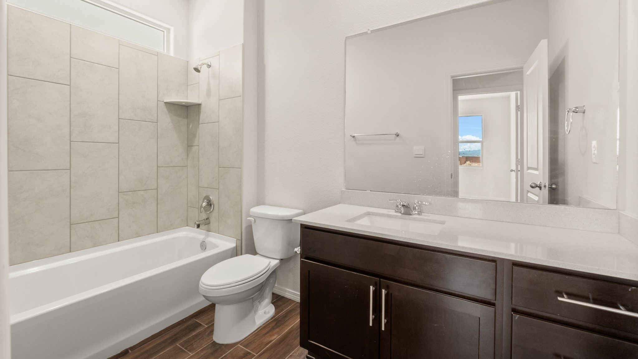 Bathroom with sink, toilet. and shower tub.