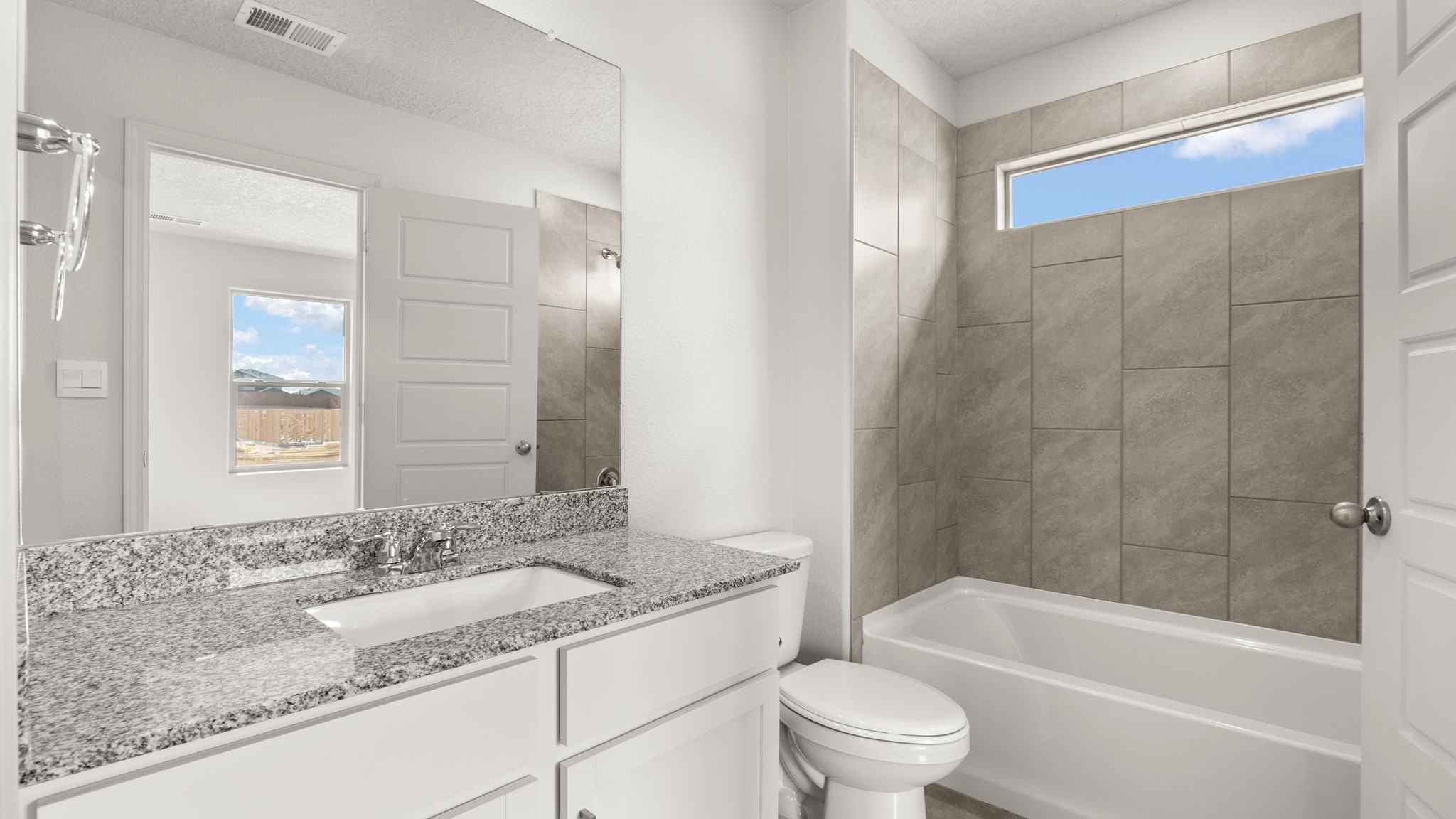Bathroom with a sink, toilet, and shower tub.