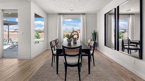 the destin dining room with tile floors and window overlooking backyard