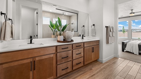 The Destin Primary Bathroom with dual vanity and two sinks, snail shower with glass, and bench