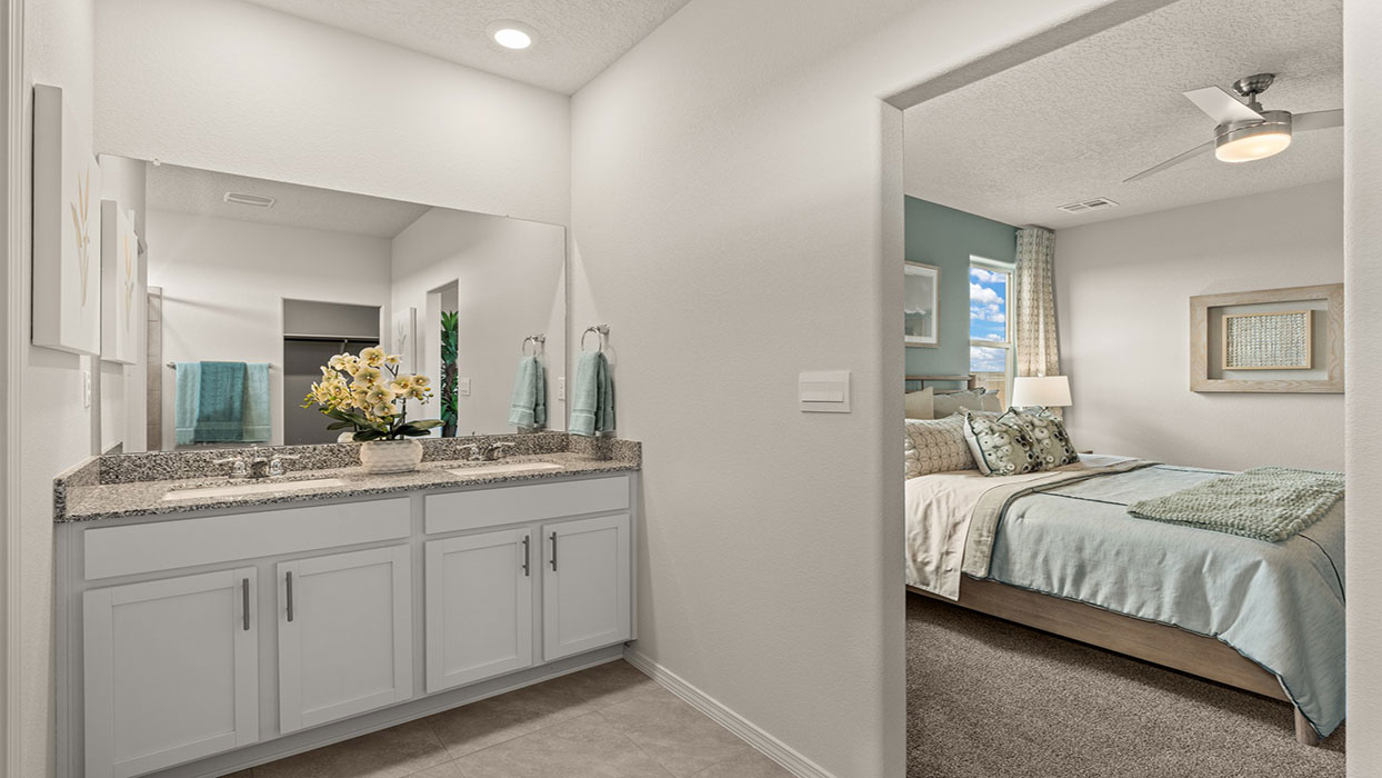 Primary ensuite looking to vanity and walk-in closet showing connection across the full suite at Los Diamantes Phase III