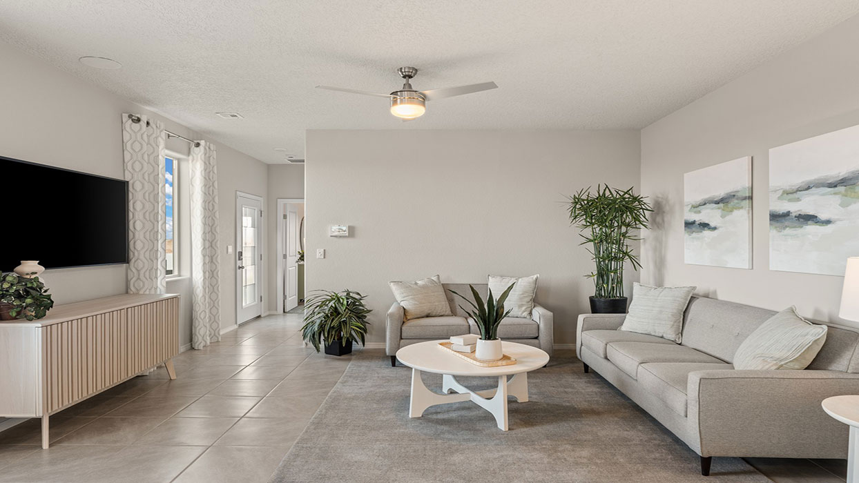 Living area showing seating layout and clear connection to dining and kitchen zones at Los Diamantes Phase III