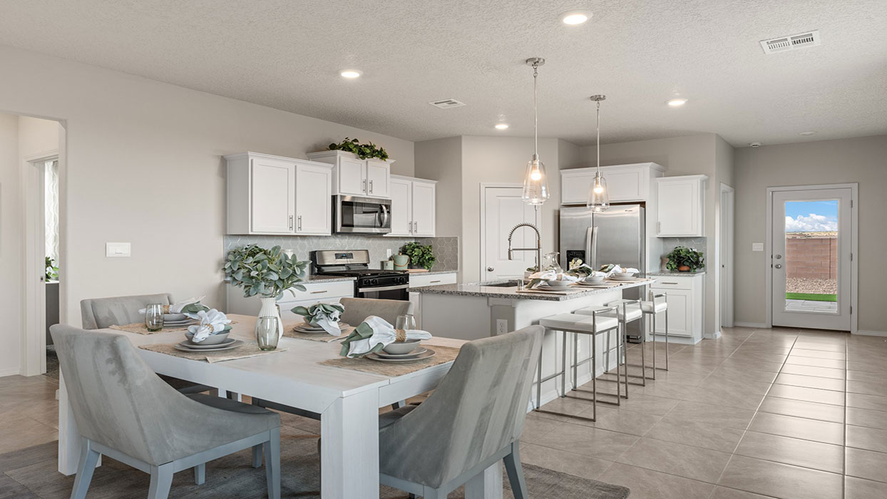 Dining area looking into kitchen showing open floorflow and adjacent living space at Los Diamantes Phase III