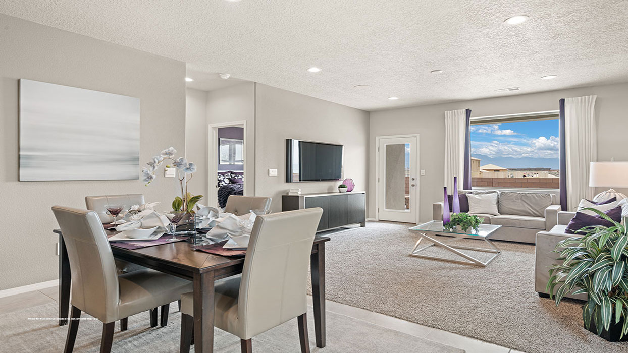 Dining looking to kitchen with clear sightlines to meal prep and gathering areas at Los Diamantes Phase III