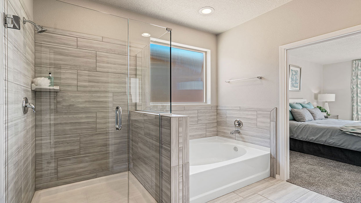 Owner’s ensuite looking toward walk-in shower and closet featuring spa-inspired finishes at Los Diamantes Phase III