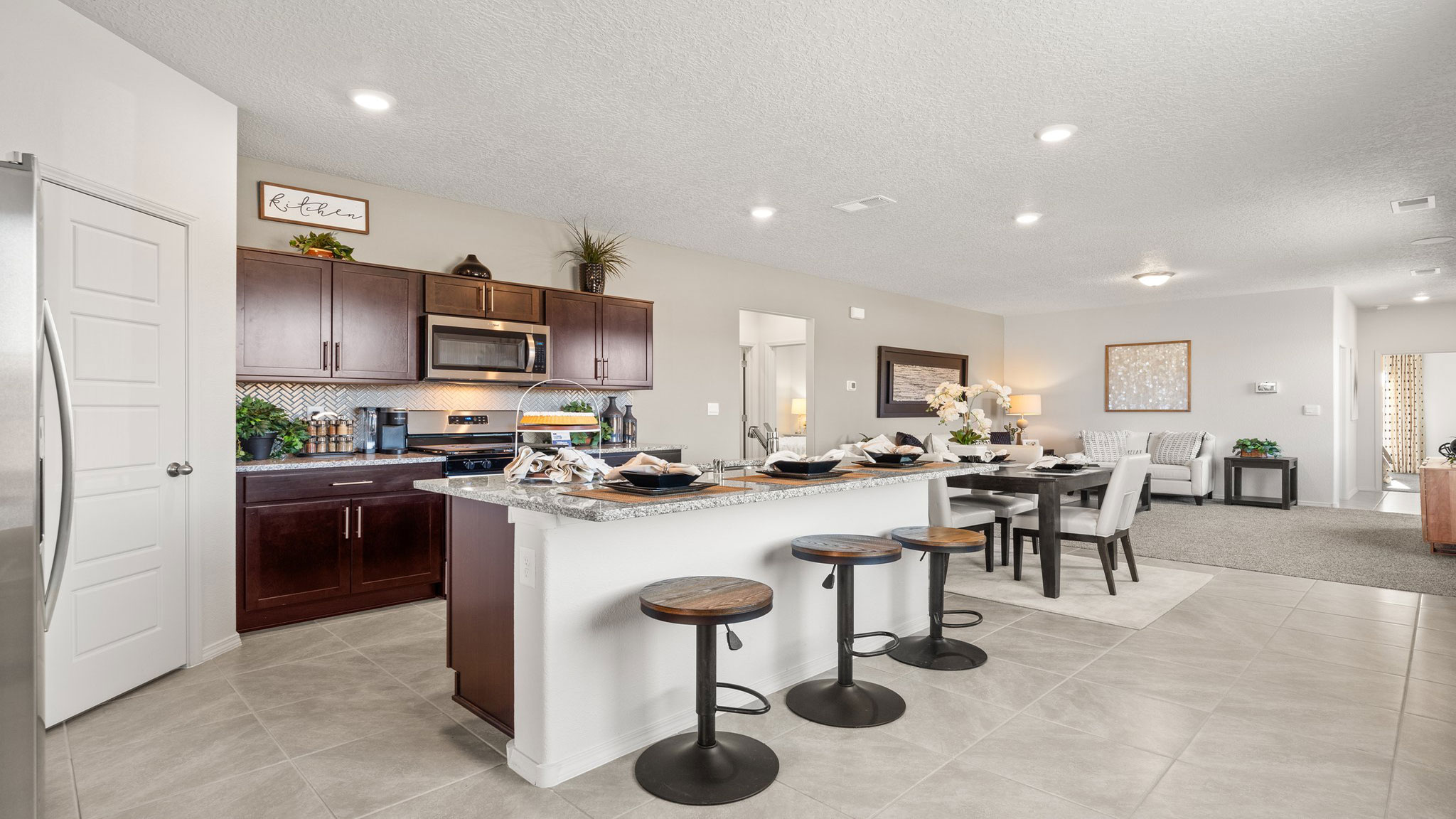Interior kitchen with center island and brown cabinets