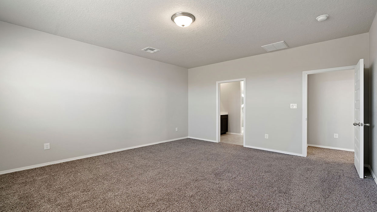 Owner’s suite offers natural window light, a spa-inspired ensuite bathroom, and spacious walk-in closet for everyday comfort