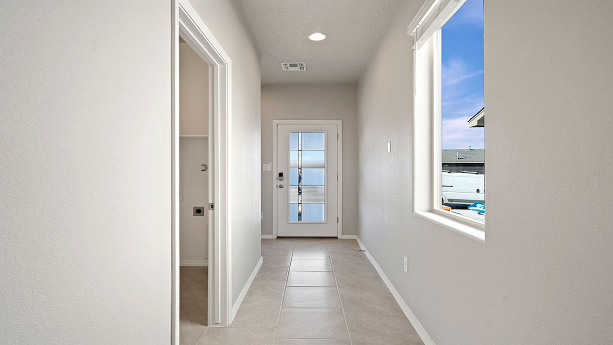 Entry hallway looking from front porch to open designed flex and living spaces, upstairs access Fiesta Del Norte