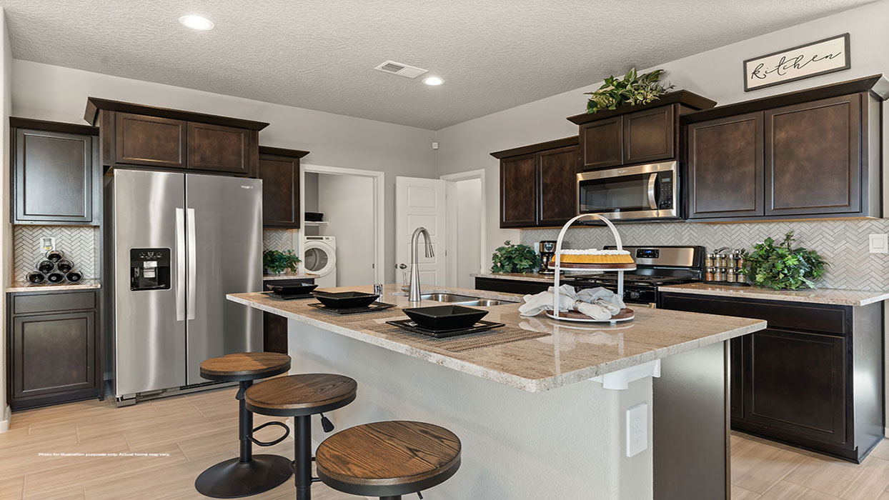 Interior kitchen with center island and dark brown cabinets