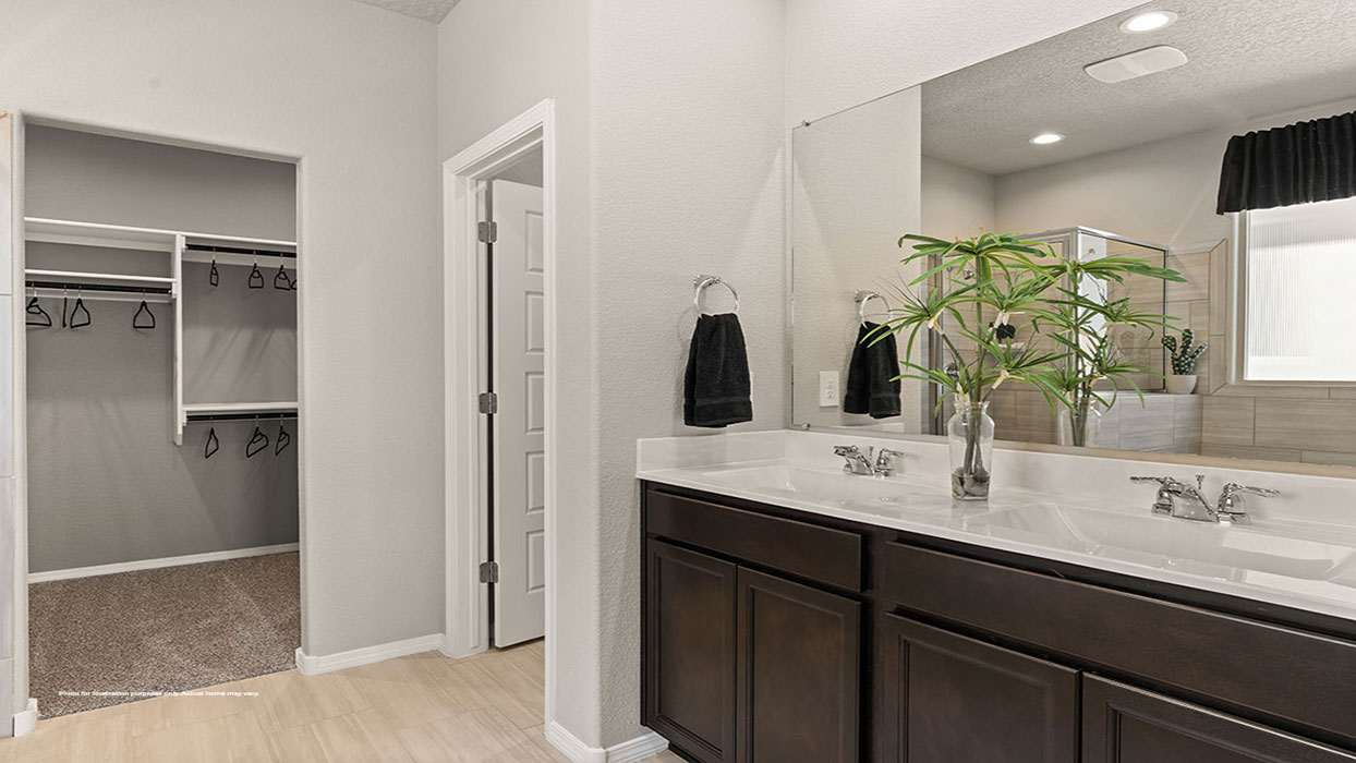 Interior bathroom with double sink and walk-in closet