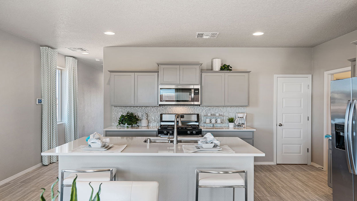 Interior kitchen with center island and light grey cabinets