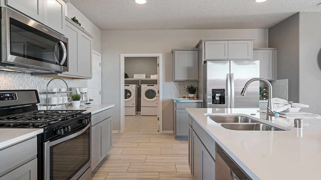 Interior kitchen with center island and light grey cabinets