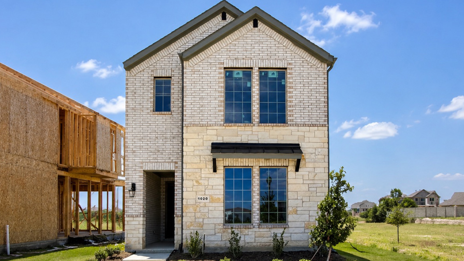 Exterior two-story new construction, brick house in DFW.