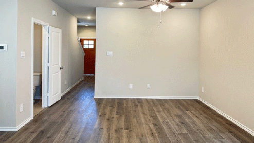 Living area that leads to front door & powder bath