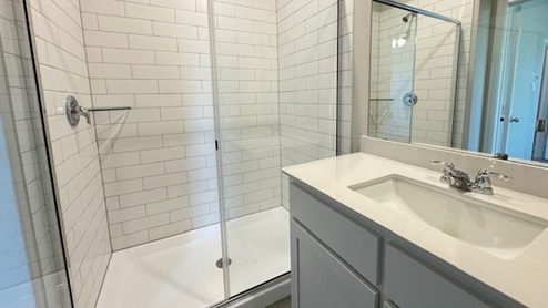 Bathroom with shower and vanity