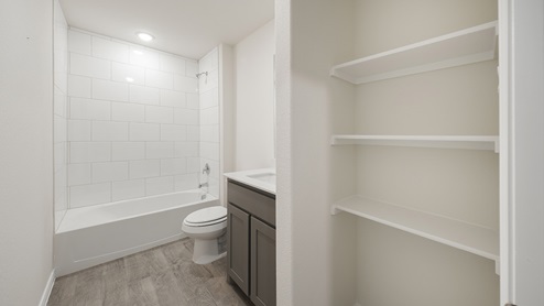 Interior bathroom with full size shower and vanity with sink