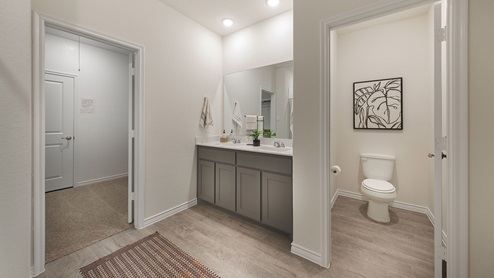 Interior bathroom with toilet room and vanity with two sinks