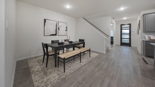 Interior dining area open to kitchen and stairs