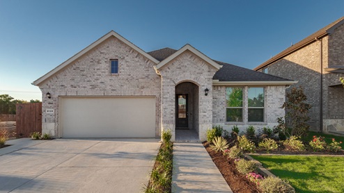 Exterior of one story home with light colored brick