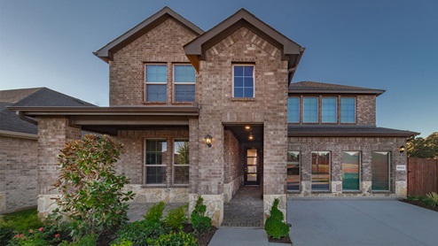 Exterior of two story home with brick and lime stone