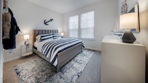 Interior bedroom with two large windows