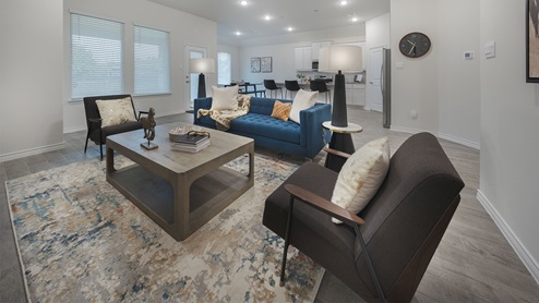 Interior livingroom open to kitchen with large windows