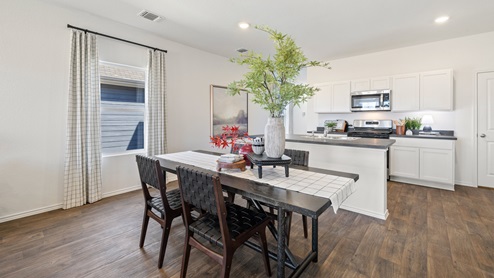 Dining area with the kitchen area behind.