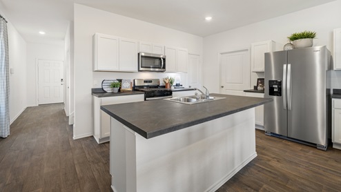 Kitchen area with the foyer behind.