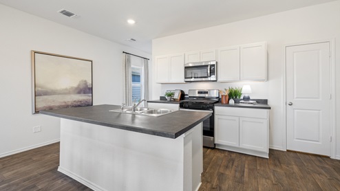 Open concept kitchen with view behind the island